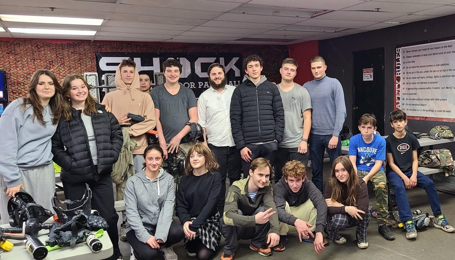 Teens standing together smiling.